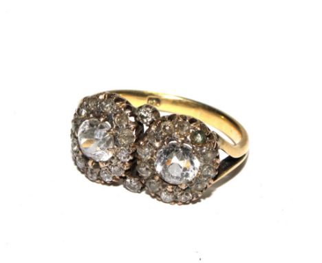 A double cluster 18c ring set with white stones.  Size M 