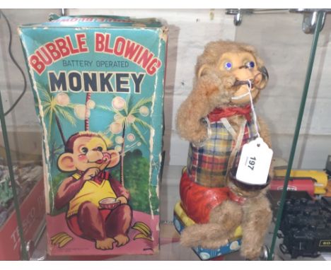 An Alps Bubble Blowing Monkey in original lidded box 26.5cm, and a miniature ceramic tea set. 