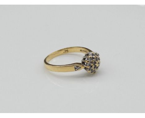 A vintage 18 carat diamond cluster ring, set with approximately 0.25 carats of brilliant cut diamonds. Shank stamped 18ct, GA