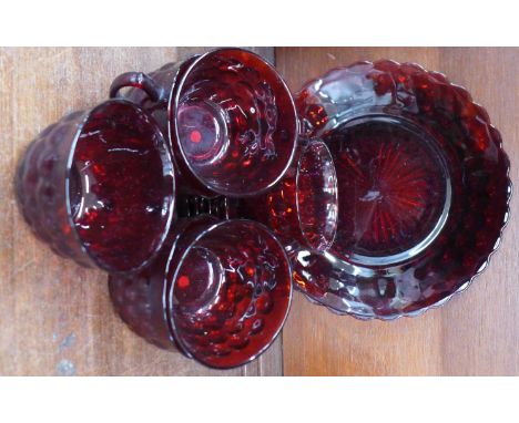 Six ruby glass cups and saucers and a sandwich plate