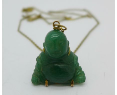 A carved jade Buddha pendant and chain, the chain marked 14k