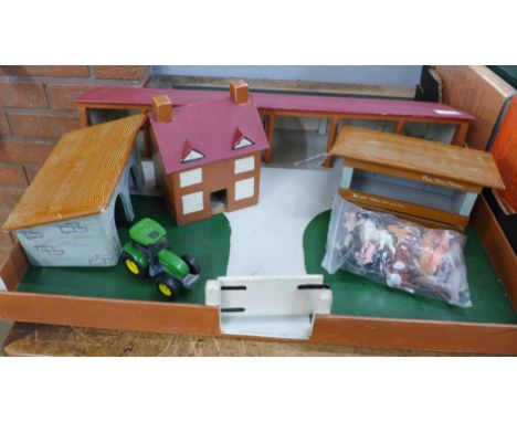 A toy farm set with animals, tractor and outbuildings