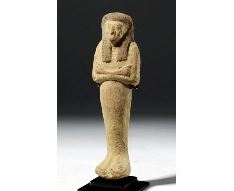Egypt, New Kingdom, ca. 1550 to 712 BCE. A tall pottery mummiform ushabti (shabti), mold-made, and painted a bright yellow-or