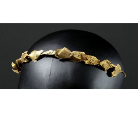 Greek, Hellenistic, ca. 4th to 3rd century BCE. A stunning gold laurel leaf diadem comprised of a band of twisted gold wire a