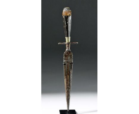 Western Europe, ca. 16th century CE. A sharp, deadly steel left-handed dagger, personalized for its owner. Swirling incised d