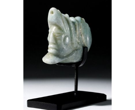 Pre-Columbian, Mayan Territories, ca. 6th to 9th c. CE. A hand-carved and hand-polished jade pendant depicting a deity with a
