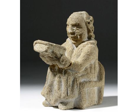 Europe, England, ca. 12th to 15th century CE. A carved white stone figurative sculpture depicting a seated gentleman of impor