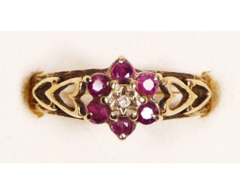 A 9ct gold ruby and diamond cluster ring, pierced heart shoulders, O, 2.4gm 