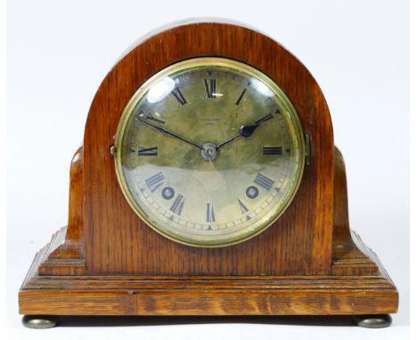 A mid 20th century oak cased mantel clock by Pearce & Sons of Leeds, having brass dial with Roman numerals, housing an 8 day 