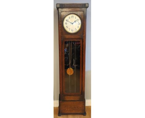 A 1950s Enfield longcase clock, oak case, having brass dial with arabic numerals housed with an eight day movement striking o