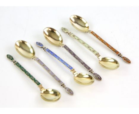 Set of six continental silver 830 grade enamel spoons with star design both front and back with gilt finish.     