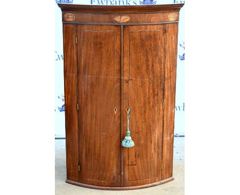 19th century mahogany bow fronted corner cabinet .     Loss of colour. Various stains. Veneer lifting in places. Deep scratch