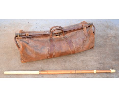 Vintage leather cricket bag and a Kendo stick.     