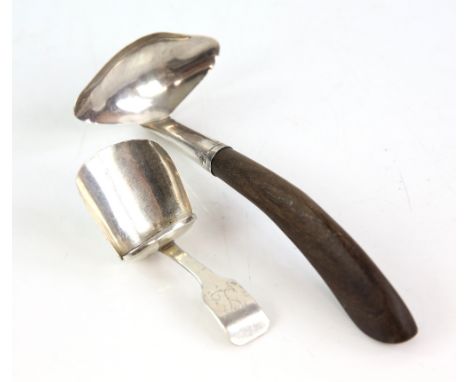 Georgian scoop form silver caddy spoon and a wooden handled silver sauce ladle .     