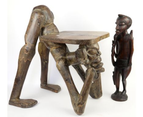 African carved hardwood stool as a a crouching man and another carved African figure.     