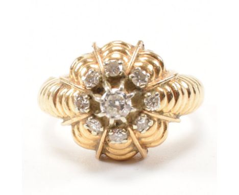 A vintage French and diamond cluster ring. The ring being set with a round cut diamond to the centre with a halo of diamonds 