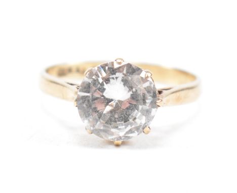 A 9ct gold and spinel set single stone ring. The ring with large spinel being basket mounted to plain band ring. Hallmarked B