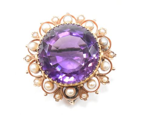An early 20th century amethyst and pearl brooch pin.&nbsp; The brooch set with a central mixed cut amethyst, framed by ten pe