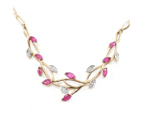 A vintage 9ct yellow gold, ruby and diamond pendant necklace chain. The pendant depicting entwined branches set with marquise