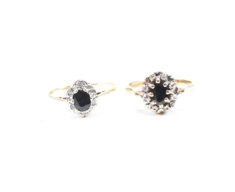 Two hallmarked 9ct yellow gold, sapphire and diamond halo rings. Both rings having an oval cut sapphire to the centre of a ha