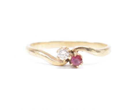 A vintage hallmarked 9ct yellow gold, diamond and ruby crossover ring. The ring having a round cut diamond and ruby in a pinc