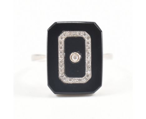 An 18ct gold enamel and diamond Art Deco panel ring. The ring being set with a rectangular black onyx / enamelled panel with 