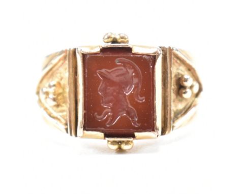 An antique 14ct yellow gold and intaglio seal ring. The signet ring having a square cut orange red stone glass intaglio panel