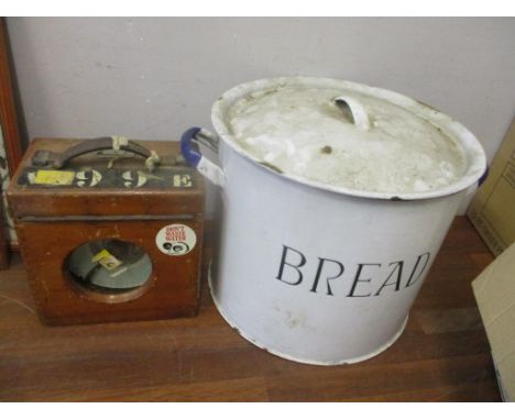 An enamel bread bin and a wooden cased pigeon clock 