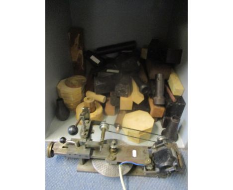 A vintage wheel cutter, together with mixed timber blocks 