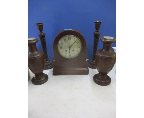 Two reproduction carved candle sticks, a pair of treen urn shaped vases and an early 20th century mahogany cased mantel clock