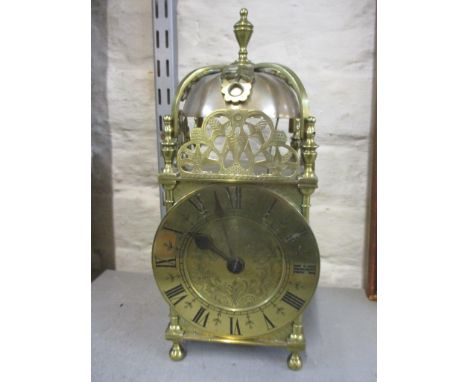 A late 19th/early 20th century lantern clock striking on a bell, the chapter ring enclosing an engraved centre signed Thomas 