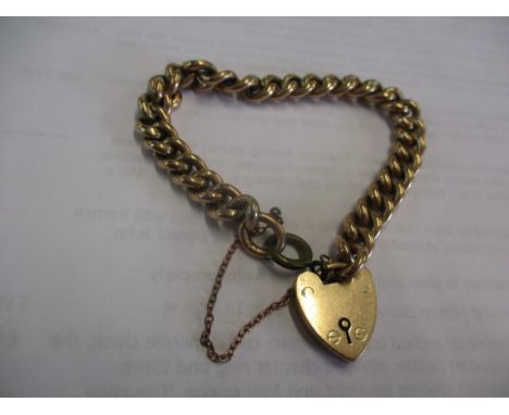 A 9ct gate-link bracelet with a 9ct gold hear shaped lock, one link gold coloured metal, safety chain unmarked yellow metal, 