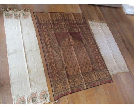 A late 19th/early 20th century Islamic silk printed prayer hanging panel, 94 x 138cm, and two prayer shawls with tasselled en