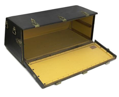 A large Louis Vuitton motoring trunk, circa 1920,black Rexine covered trunk, with sloped rear, raised on wooden battens, with
