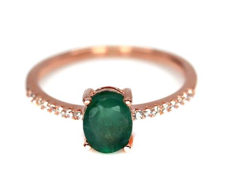 A rose gold 925 silver solitaire ring set with an oval cut emerald and white stones, (O.5).