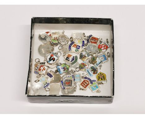 A group of over forty silver and enamel travel charms.