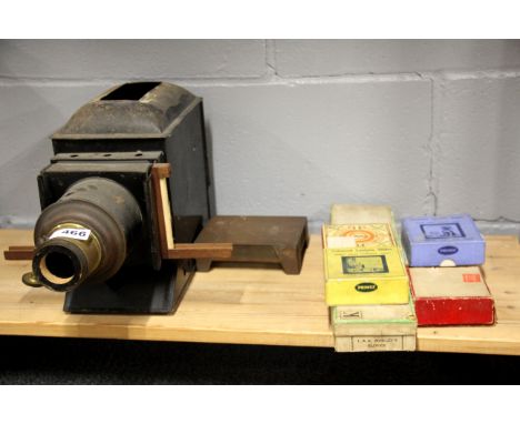 A 19th century lantern slide projector with five boxes of good glass slides, including comical cats and dogs, the Pied Piper.