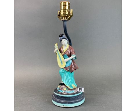 A Chinese porcelain figure mounted as a table lamp, H. 34cm.