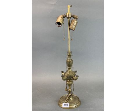 An Eastern brass oil lamp mounted as a table lamp, H. 35cm.