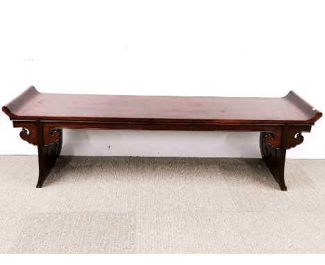 A Chinese carved hardwood low altar table, L. 160cm, H. 45cm. Minor scuffing to scroll ends.