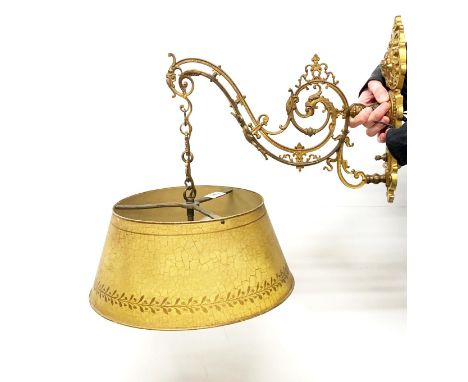 A gilt metal wall light bracket with 1930's fitting and Toleware shade, bracket 28 x 35cm, shade Dia. 31cm.