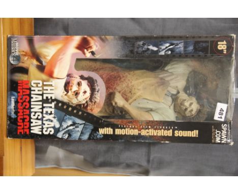 A boxed Texas Chainsaw Massacre figure.