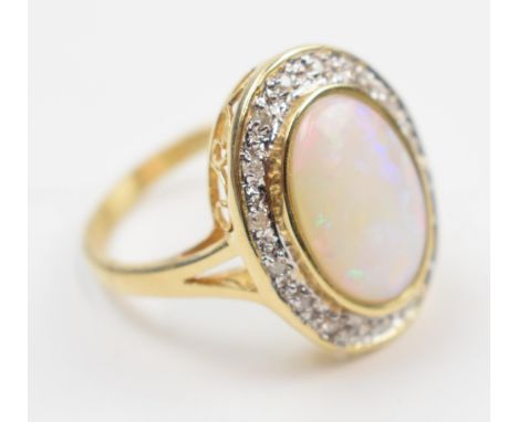 14ct gold ring set with a large opal stone surrounded by diamonds, stamped 585, 5.3 grams, size O/P.  