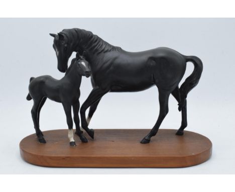 Beswick Black Beauty and Foal on wooden base.  In good condition with no obvious damage or restoration, slight chips to front