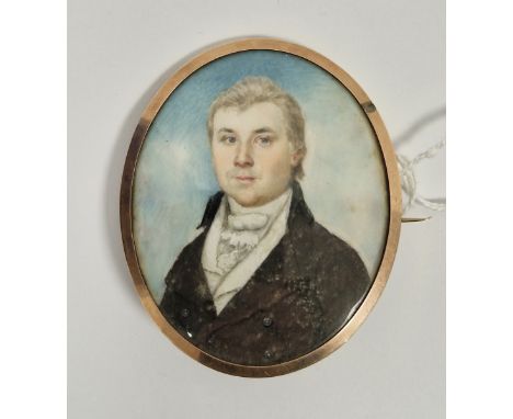 Regency portrait miniature&nbsp;of a gentleman, watercolour on ivory, painted three-quarter length wearing a dark brown jacke