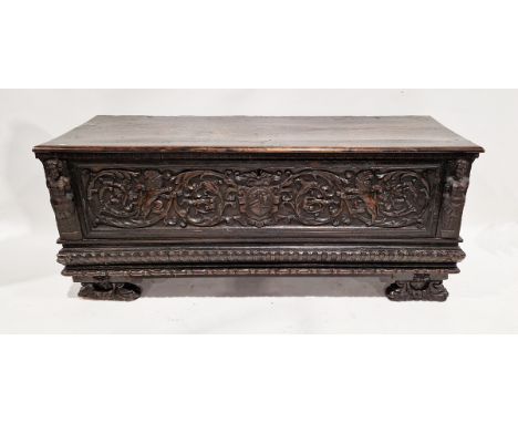 Italian 17th/18th century carved walnut cassone, the front carved in the Renaissance style with a shield-shaped coat of arms 