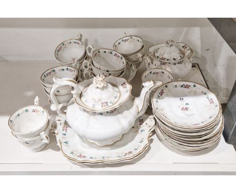 English porcelain part tea service, circa 1835, painted with sprigs of flowers and leafy tendrils within shaped gilt rims, co