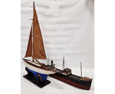 Mid-20th century pond yacht, with a blue painted hull, sails and rigging, on ebonised stand, 63cm wide, a vintage kit model o