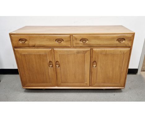 Ercol light elm 'Windsor' sideboard, having two drawers above a three cupboard doors, the right side cupboard with integral c