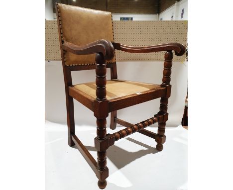 Oak open armchair with studded back bobbin supports.